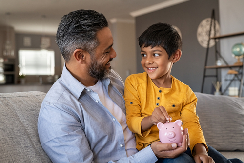 Father and son putting money in piggy bank _ home services _ House Service App