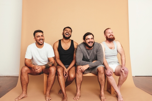 Four men of different dress sizes and body habitus sat on a bench and smiling _ House Service App